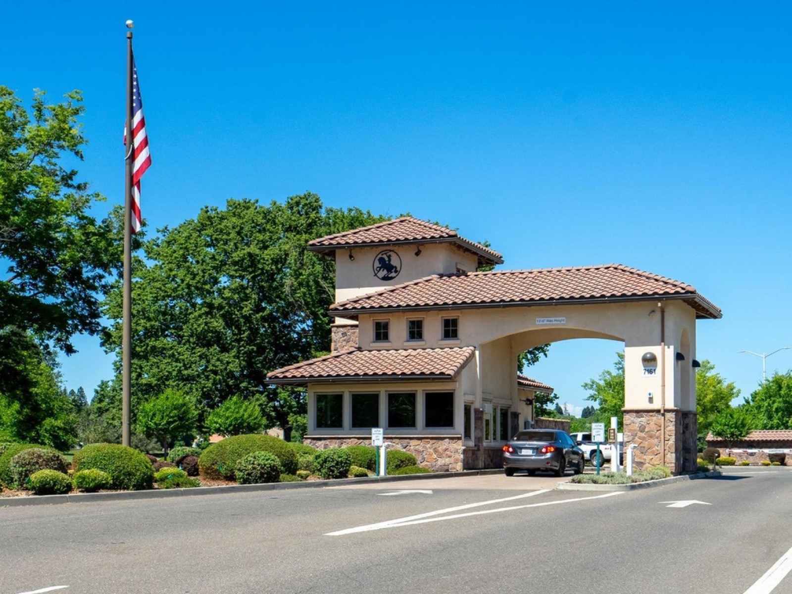 The guarded entrance gate to Rancho Murieta, with an American flag out front