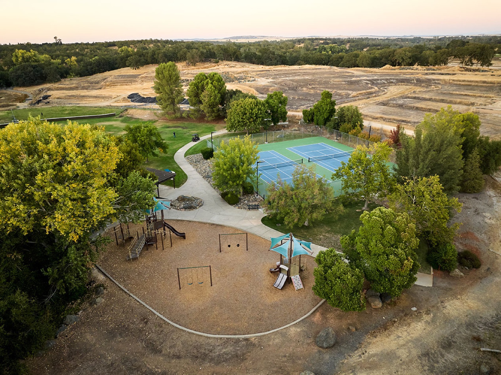 Aerial view of Riverview Park with a playground and tennis courts
