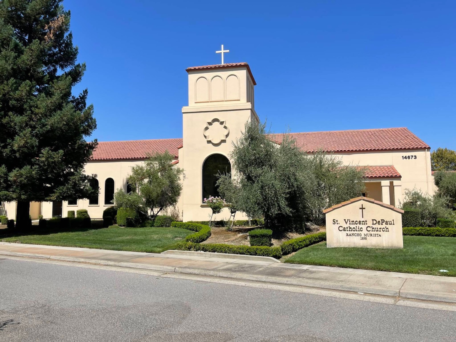 Saint Vincent DePaul Catholic Church, a stucco building with a bell tower and red tile roof
